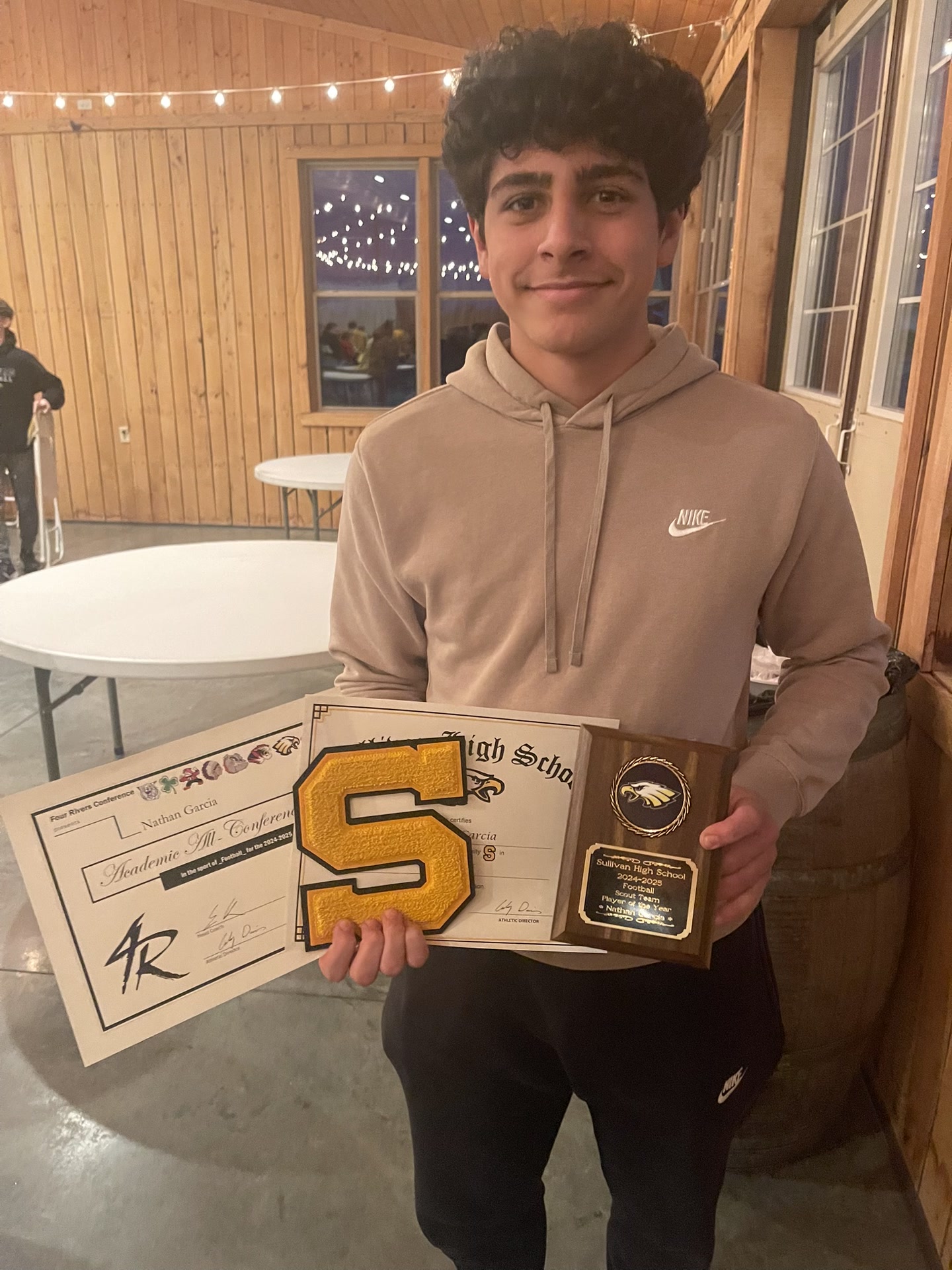Nathan Garcia holding Scout Player of the Year plaque, varsity letter, and Academic All-Conference certificate