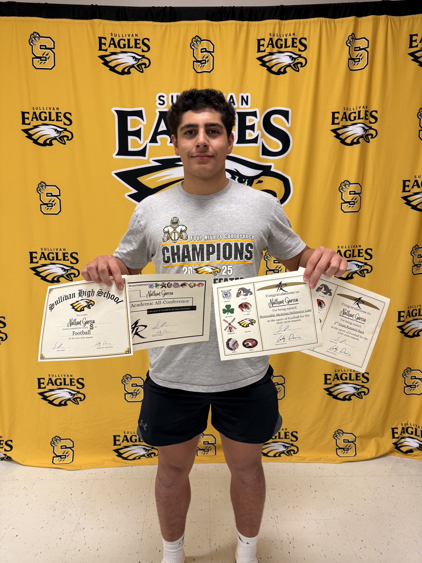 Nathan Garcia with Academic All-Conference and championship certificates
